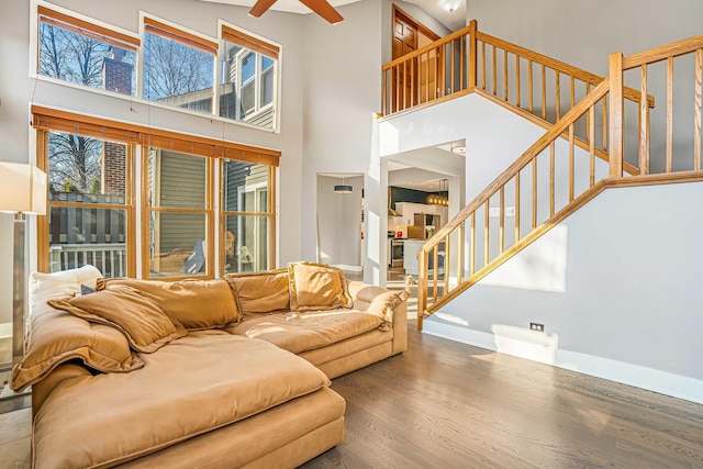 971 Heathrow Ln, Naperville, IL 60540 - living area with wood finished floors, stairs, a high ceiling, a ceiling fan, and baseboards