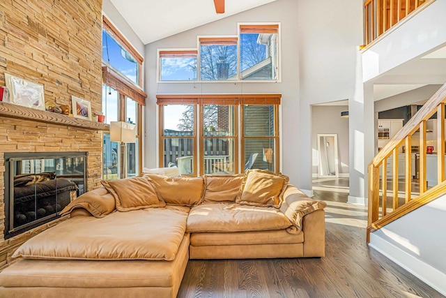 971 Heathrow Ln, Naperville, IL 60540 - living room featuring wood finished floors, high vaulted ceiling, stairs, a fireplace, and a ceiling fan
