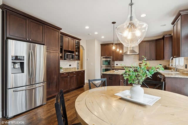 42 Lincoln St, Glenview, IL 60025 - kitchen featuring appliances with stainless steel finishes, dark wood-style floors, dark brown cabinetry, backsplash, and a center island