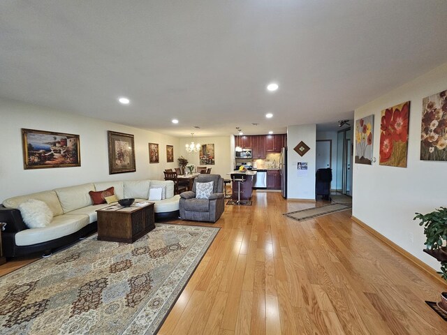 3110 Pheasant Creek Dr Unit 304, Northbrook, IL 60062 - living area featuring a chandelier, recessed lighting, light wood-style floors, and baseboards