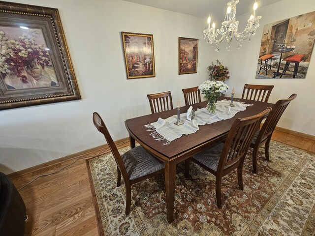 3110 Pheasant Creek Dr Unit 304, Northbrook, IL 60062 - dining space featuring a chandelier, baseboards, and wood finished floors