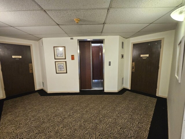 3110 Pheasant Creek Dr Unit 304, Northbrook, IL 60062 - hall with baseboards, a drop ceiling, elevator, and dark carpet