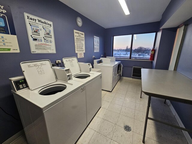 3110 Pheasant Creek Dr Unit 304, Northbrook, IL 60062 - shared laundry room featuring washer and clothes dryer, baseboards, and light tile patterned flooring