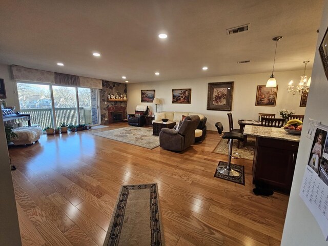3110 Pheasant Creek Dr Unit 304, Northbrook, IL 60062 - living area featuring wood-type flooring, recessed lighting, a chandelier, and a stone fireplace