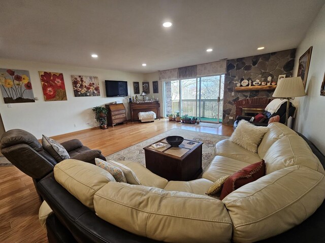3110 Pheasant Creek Dr Unit 304, Northbrook, IL 60062 - living area with wood finished floors, recessed lighting, and a stone fireplace