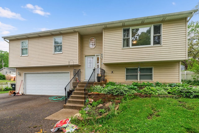 411 N Crestwood Ave, Mchenry, IL 60051 - bi-level home featuring an attached garage and driveway