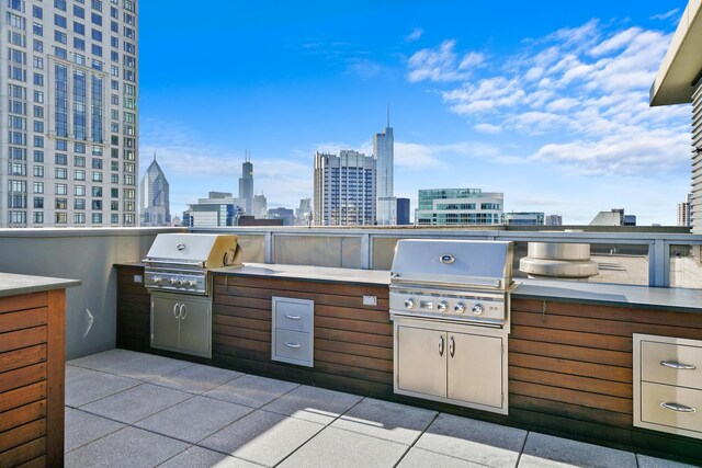 600 N Lake Shore Dr Unit 1105, Chicago, IL 60611 - view of patio featuring a grill, exterior kitchen, and a view of skyline