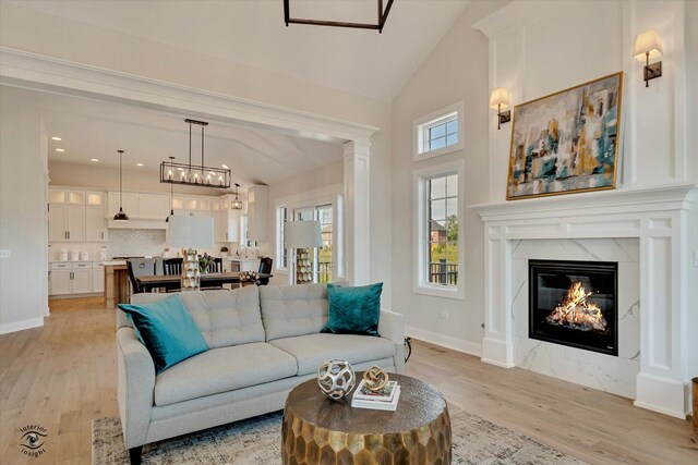 8806 Indiana Harbor Dr, Frankfort, IL 60423 - living area with light wood finished floors, baseboards, a fireplace, high vaulted ceiling, and recessed lighting