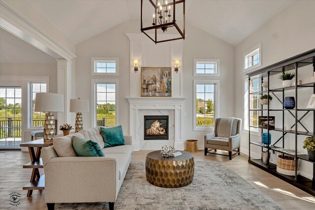8806 Indiana Harbor Dr, Frankfort, IL 60423 - living area featuring plenty of natural light, high vaulted ceiling, a high end fireplace, wood finished floors, and a chandelier