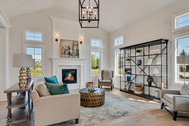 8806 Indiana Harbor Dr, Frankfort, IL 60423 - living room featuring a premium fireplace, healthy amount of natural light, a chandelier, high vaulted ceiling, and wood finished floors