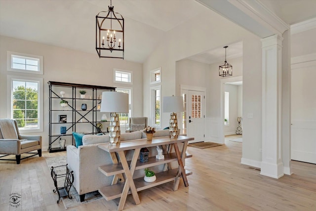 8806 Indiana Harbor Dr, Frankfort, IL 60423 - living area featuring a chandelier, plenty of natural light, light wood finished floors, a towering ceiling, and baseboards