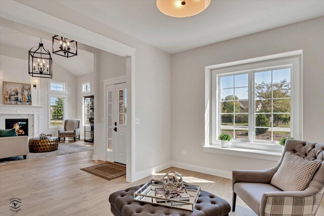 8806 Indiana Harbor Dr, Frankfort, IL 60423 - living area with healthy amount of natural light, vaulted ceiling, light wood-style flooring, and baseboards