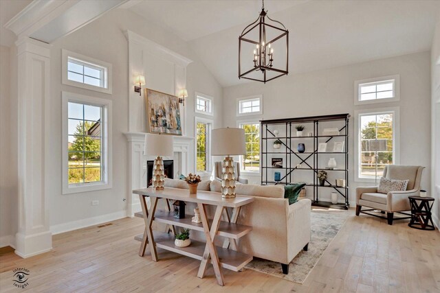 8806 Indiana Harbor Dr, Frankfort, IL 60423 - living area with a fireplace, light wood-type flooring, high vaulted ceiling, baseboards, and a chandelier