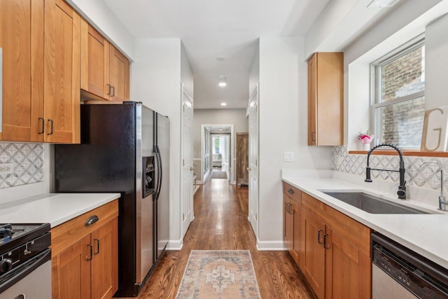 5140 N Albany Ave Unit 1, Chicago, IL 60625 - kitchen featuring appliances with stainless steel finishes, a sink, dark wood-style floors, healthy amount of natural light, and recessed lighting
