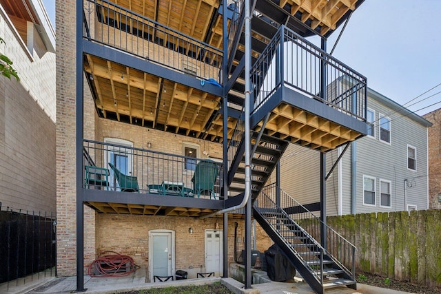 5140 N Albany Ave Unit 1, Chicago, IL 60625 - rear view of property with stairs, brick siding, and a balcony