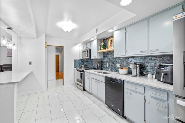 kitchen featuring stainless steel appliances, a sink, baseboards, decorative backsplash, and open shelves