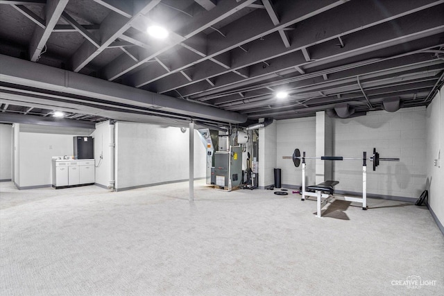 basement featuring heating unit and carpet