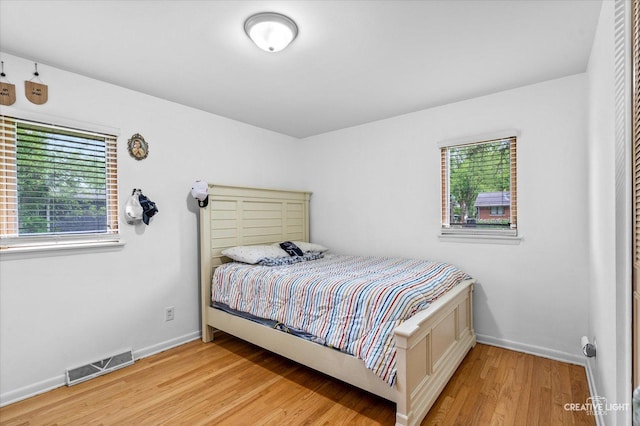 bedroom featuring light wood-style flooring and baseboards