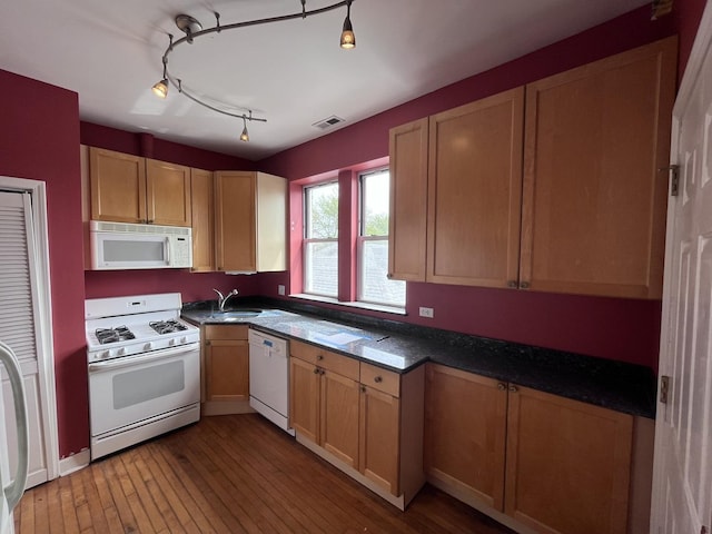 3353 W Wilson Ave Unit 3F, Chicago, IL 60625 - kitchen featuring white appliances, a sink, dark countertops, and wood-type flooring