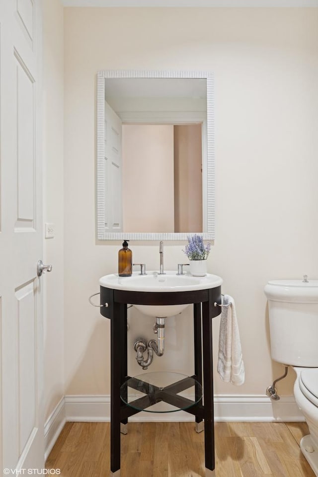 333 N Canal St Unit 2201, Chicago, IL 60606 - half bathroom featuring toilet and wood finished floors