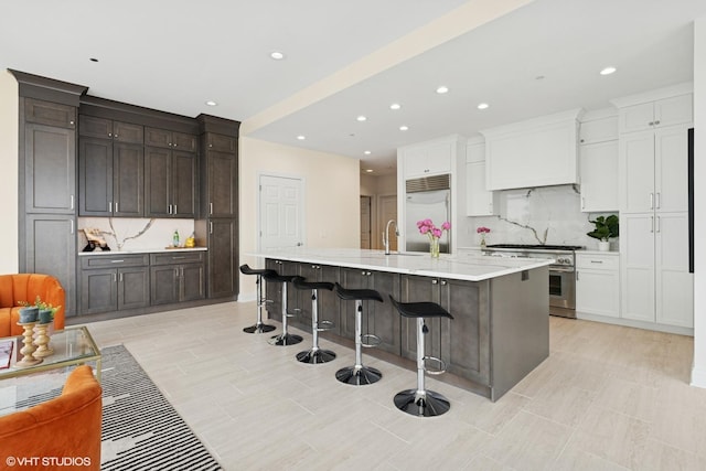 333 N Canal St Unit 2201, Chicago, IL 60606 - kitchen with high quality appliances, tasteful backsplash, dark brown cabinets, recessed lighting, and a breakfast bar area