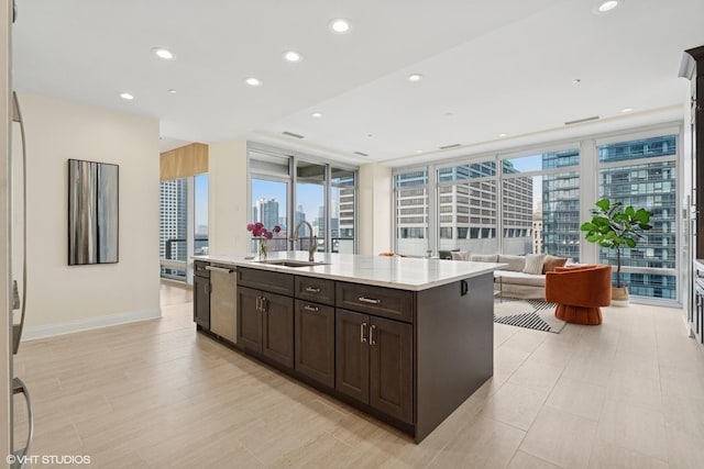 333 N Canal St Unit 2201, Chicago, IL 60606 - kitchen with a skyline view, dark brown cabinetry, light countertops, dishwasher, and an island with sink