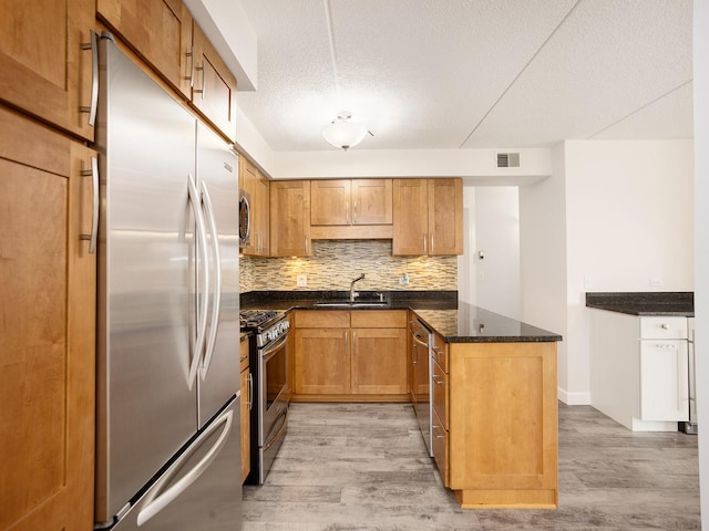 8540 W Foster Ave Unit 403, Norridge, IL 60706 - kitchen featuring stainless steel appliances, a sink, light wood finished floors, tasteful backsplash, and a textured ceiling
