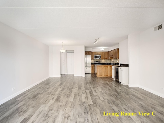 8540 W Foster Ave Unit 403, Norridge, IL 60706 - unfurnished living room with wood finished floors, wine cooler, and baseboards