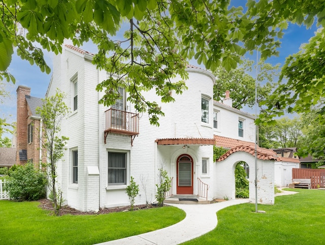 5803 N Kolmar Ave, Chicago, IL 60646 - view of front of house featuring a balcony, a chimney, brick siding, and a tile roof