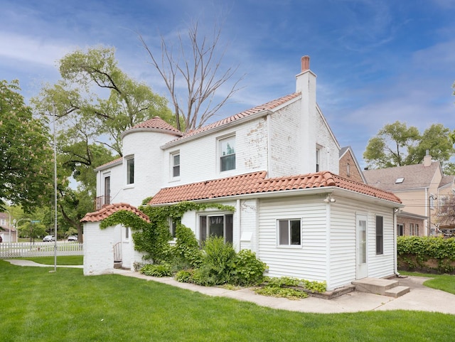 5803 N Kolmar Ave, Chicago, IL 60646 - rear view of property with a chimney and a tiled roof