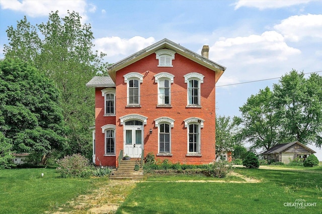 730 E Main St, Amboy, IL 61310 - italianate home with a chimney, brick siding, and a front lawn