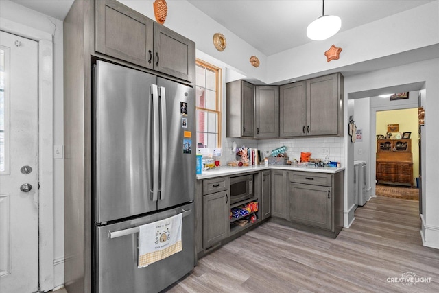 730 E Main St, Amboy, IL 61310 - kitchen featuring stainless steel appliances, light countertops, backsplash, light wood finished floors, and gray cabinets