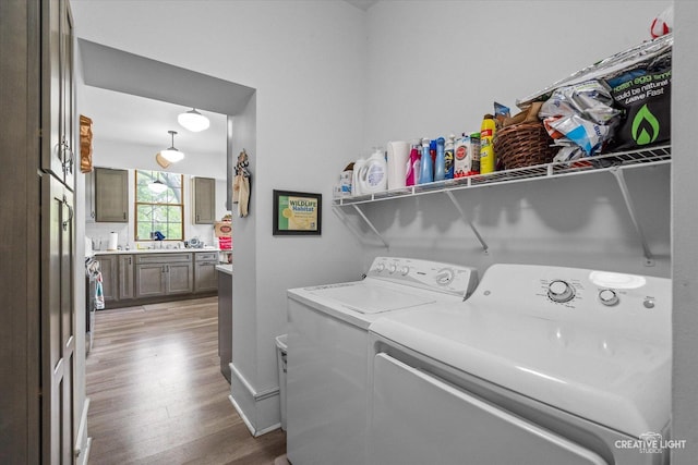 730 E Main St, Amboy, IL 61310 - washroom featuring independent washer and dryer, light wood-style flooring, and a sink