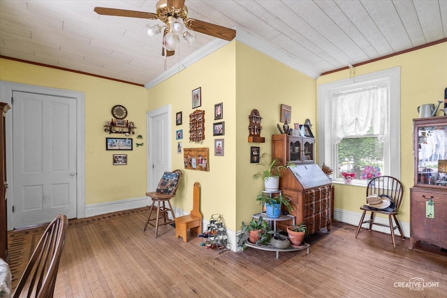 730 E Main St, Amboy, IL 61310 - living area with ornamental molding, wood-type flooring, a ceiling fan, baseboards, and wood ceiling