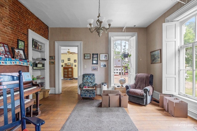 730 E Main St, Amboy, IL 61310 - sitting room featuring wood finished floors, a chandelier, and wallpapered walls