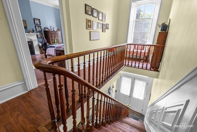 730 E Main St, Amboy, IL 61310 - staircase featuring wood finished floors, healthy amount of natural light, and baseboards