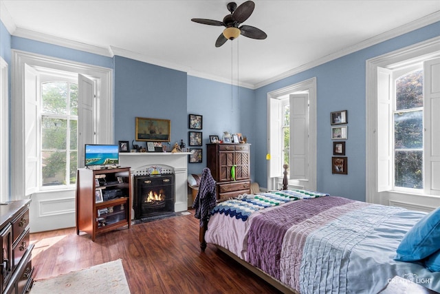 730 E Main St, Amboy, IL 61310 - bedroom featuring wood finished floors, ornamental molding, a warm lit fireplace, and ceiling fan