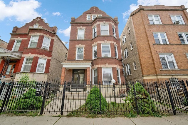 2655 S Millard Ave, Chicago, IL 60623 - view of front of house with a fenced front yard, cooling unit, and brick siding