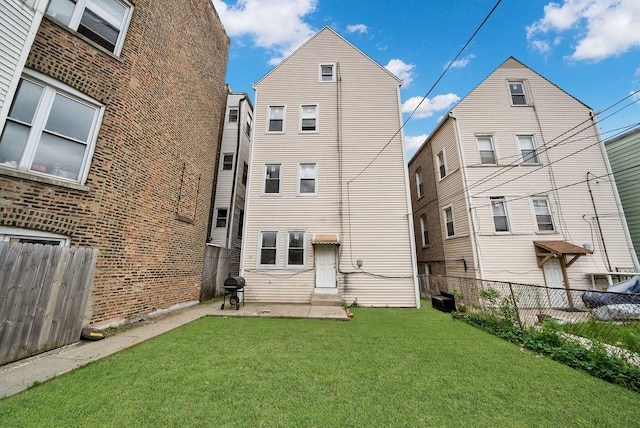 2655 S Millard Ave, Chicago, IL 60623 - back of property with central AC unit, entry steps, and a patio