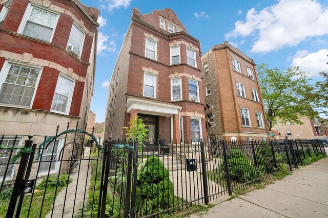 2655 S Millard Ave, Chicago, IL 60623 - view of front of house featuring a fenced front yard and brick siding