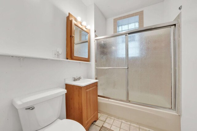 2655 S Millard Ave, Chicago, IL 60623 - bathroom with tile patterned floors, toilet, bath / shower combo with glass door, and vanity
