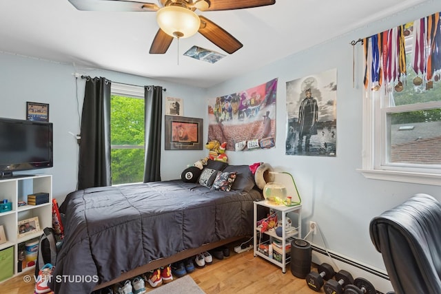 5720 Dunham Rd, Downers Grove, IL 60516 - bedroom featuring wood finished floors, a ceiling fan, and baseboard heating