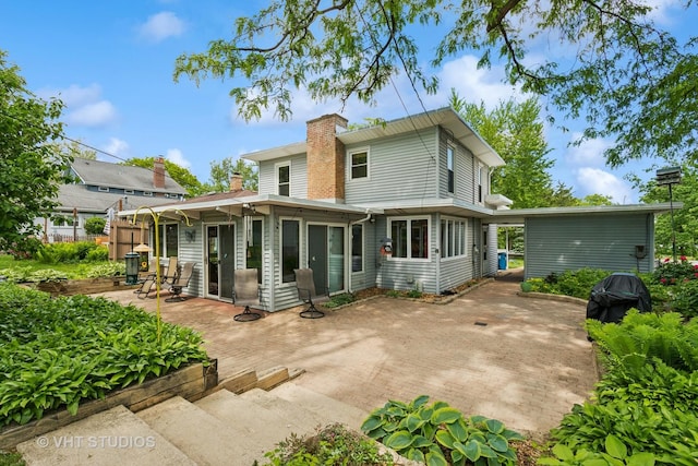 5720 Dunham Rd, Downers Grove, IL 60516 - rear view of property with a patio, a chimney, and a sunroom