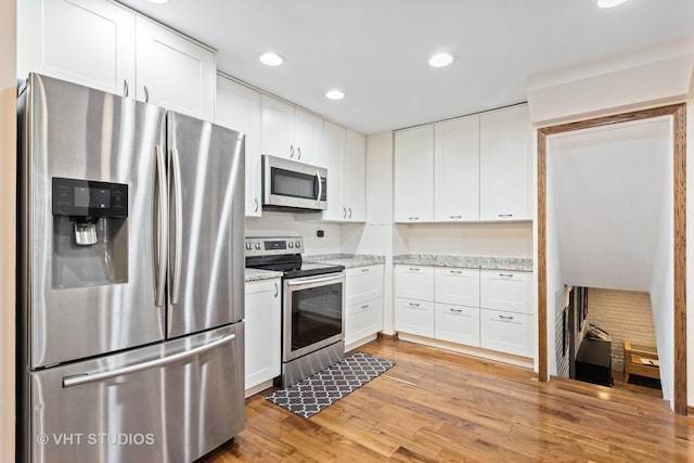 5720 Dunham Rd, Downers Grove, IL 60516 - kitchen with appliances with stainless steel finishes, white cabinets, light wood-style floors, light stone counters, and recessed lighting
