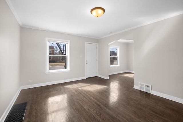 228 E 140th Pl, Dolton, IL 60419 - unfurnished room with wood finished floors, ornamental molding, baseboards, and arched walkways