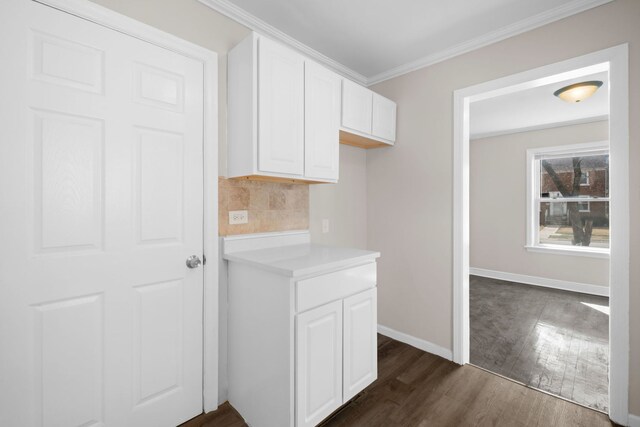 228 E 140th Pl, Dolton, IL 60419 - kitchen with dark wood-style flooring, white cabinetry, backsplash, light countertops, and ornamental molding