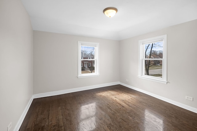 228 E 140th Pl, Dolton, IL 60419 - unfurnished room featuring plenty of natural light, dark wood-type flooring, and baseboards