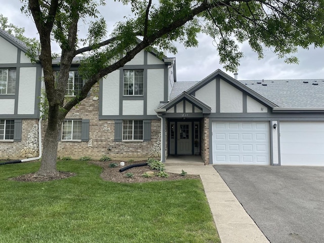 1219 Williamsport Dr Unit 28-3, Westmont, IL 60559 - tudor-style house featuring stucco siding, asphalt driveway, an attached garage, and a front lawn