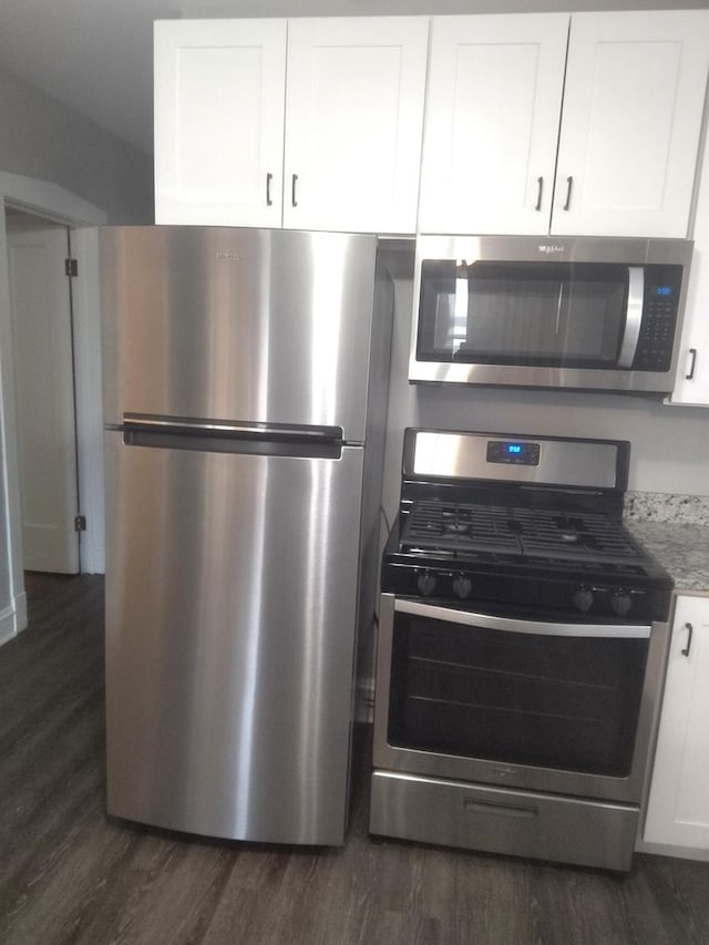 1438 Maple Ave, Berwyn, IL 60402 - kitchen featuring appliances with stainless steel finishes, dark wood-style floors, and white cabinets
