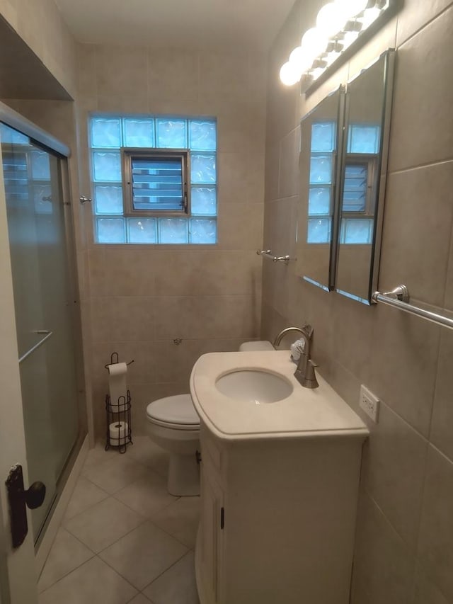 1438 Maple Ave, Berwyn, IL 60402 - bathroom with tile walls, vanity, a stall shower, tile patterned flooring, and toilet